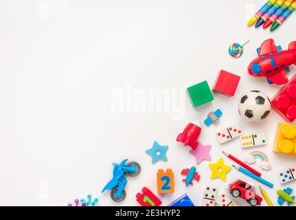 Frame of kids toys on white background with blank space for text. Top view, flat lay. Stock Photo