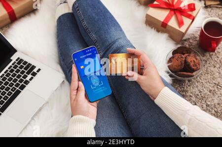 Unrecognizable Woman Using Smartphone Paying With Mobile Wallet Sitting Indoors Stock Photo