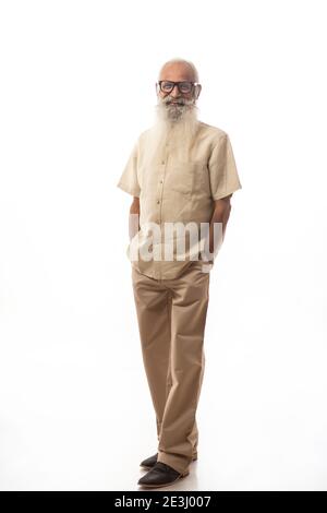 AN OLD MAN WITH LONG BEARD CONFIDENTLY STANDING IN FRONT OF CAMERA Stock Photo