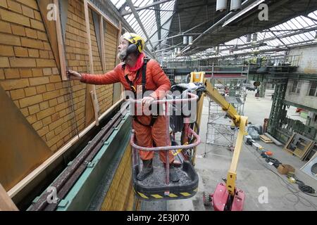 Berlin, Germany. 19th Jan, 2021. Artist Ralf Schmerberg stands on a lifting platform in a former AEG industrial hall in Oberschöneweide. Under the name 'Mahalla', a place for culture is to be created in Hall 10. Credit: Jörg Carstensen/dpa/Alamy Live News Stock Photo