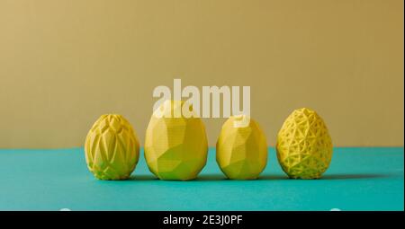 Four yellow Easter eggs with geometric patterns on yellow and green background with blank space for text. Horizontal panoramic banner. Stock Photo