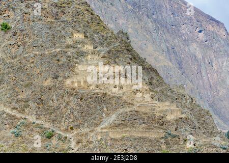 View of Pinkuylluna mountain and qullqas from Ollantaytambo, an Inca archaeological site in the Sacred Valley in Urubamba, Cusco Region, southern Peru Stock Photo