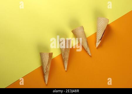 Emty Ice cream cones pattern on colored background. Top view. Several wafer ice cream cones designe Stock Photo