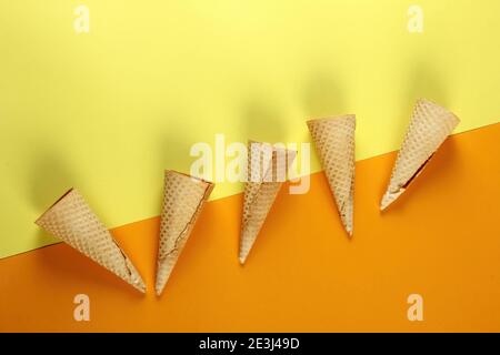 Emty Ice cream cones pattern on colored background. Top view. Several wafer ice cream cones designe Stock Photo