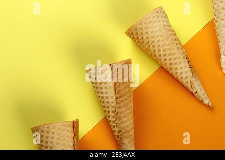 Emty Ice cream cones pattern on colored background. Top view. Several wafer ice cream cones designe Stock Photo