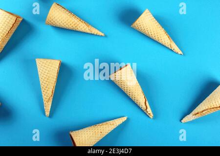 Emty Ice cream cones pattern on colored background. Top view. Several wafer ice cream cones designe Stock Photo
