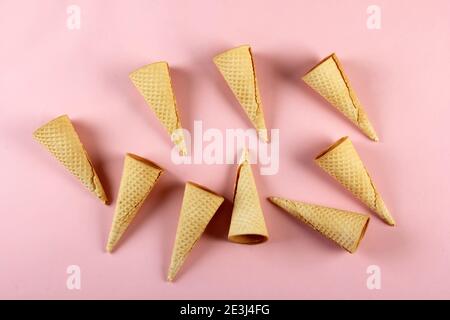 Emty Ice cream cones pattern on colored background. Top view. Several wafer ice cream cones designe Stock Photo