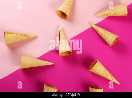 Emty Ice cream cones pattern on colored background. Top view. Several wafer ice cream cones designe Stock Photo