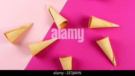 Emty Ice cream cones pattern on colored background. Top view. Several wafer ice cream cones designe Stock Photo