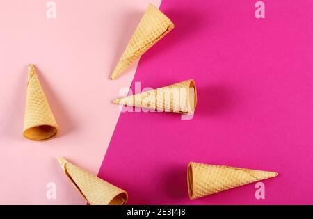 Emty Ice cream cones pattern on colored background. Top view. Several wafer ice cream cones designe Stock Photo