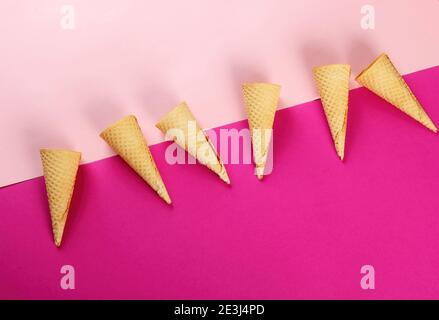 Emty Ice cream cones pattern on colored background. Top view. Several wafer ice cream cones designe Stock Photo