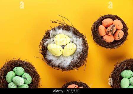Bird nests with eggs on a colored background, Easter concept. Top view, selective focus, copy space Stock Photo