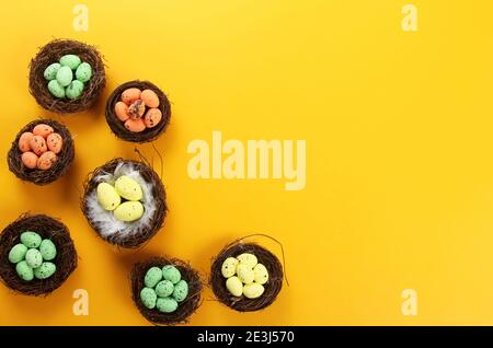 Bird nests with eggs on a colored background, Easter concept. Top view, selective focus, copy space Stock Photo