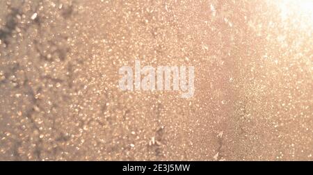 Shiny golden abstract background. Defocused sunlight through frosty patterns on the glass Stock Photo