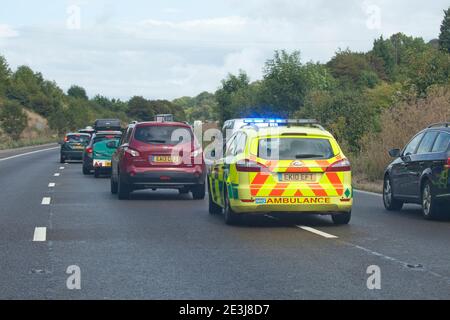 Ambulance responding to an emergency on busy motorway. England Stock Photo