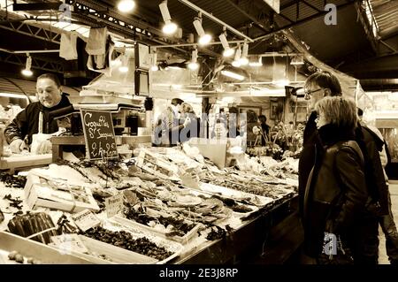 PARIS, FRANCE - JANUARY 28, 2017: People buy seafood at Marche des Enfants Rouges ('Red Children Market '). This oldest covered market in Paris known Stock Photo