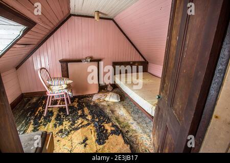 A bedroom in an abandoned derelict cottage. Stock Photo