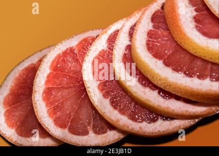 Red oranges slices of Sicily stacked orange background Stock Photo