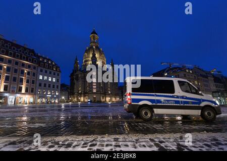 Dresden, Germany. 18th Jan, 2021. A police car drives across the Neumarkt in front of the Frauenkirche in the evening. Credit: Robert Michael/dpa-Zentralbild/dpa/Alamy Live News Stock Photo