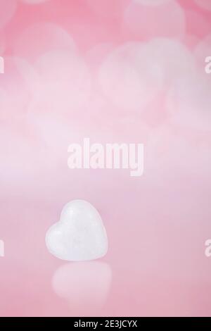 One white heart on a pink with bohe background Stock Photo