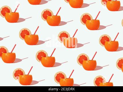 Creative pattern with  orange juice in the peel over white background .Minimal sunlit citrus layout.Isometric view. Stock Photo