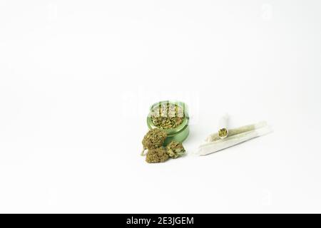 Marijuana buds and joint lie on a dark gray background. Grinder near  cannabis. Marijuana is medicine Stock Photo - Alamy