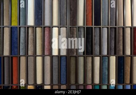 Samples of colored carpets at the stand. Various carpet designs for the interior. Stock Photo