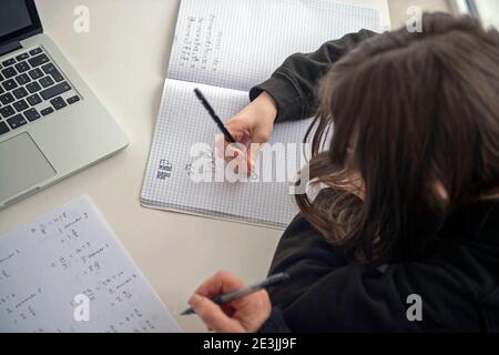 A child being home schooled with the help of a parent in the UK while both secondary and primary schools across the UK are still closed to the current Stock Photo