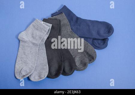 Classic mens multicolored socks on a blue background, mens clothing. Stock Photo