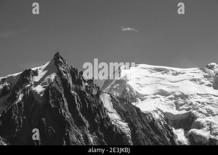 View of Aiguille du Midi in Mont Blanc massif within the French Alps in summer from Plan Praz. Black white historic photo. Stock Photo