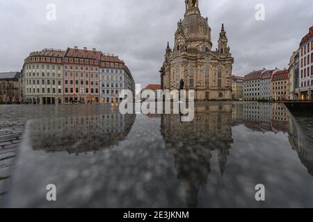 Dresden, Germany. 19th Jan, 2021. The Frauenkirche and the houses on the Neumarkt are reflected in a wet stone bank in the afternoon. Credit: Robert Michael/dpa-Zentralbild/dpa/Alamy Live News Stock Photo