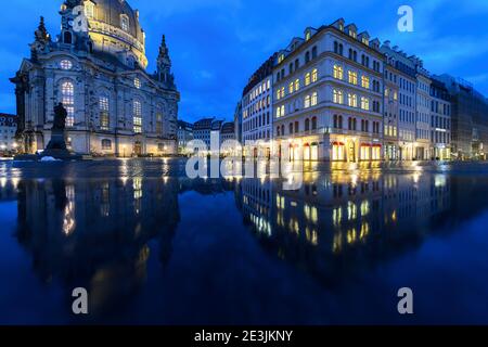 Dresden, Germany. 19th Jan, 2021. The Frauenkirche (l) and the houses on the Neumarkt are reflected in a wet stone bank in the late afternoon. Credit: Robert Michael/dpa-Zentralbild/dpa/Alamy Live News Stock Photo