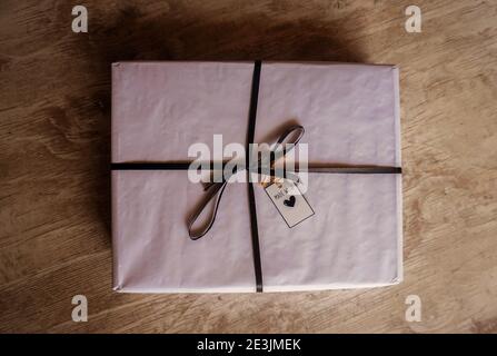 gift box with tag on wooden background Stock Photo