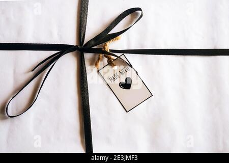 gift box with tag on wooden background Stock Photo