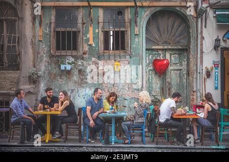 Istanbul, Turkey - September 17 2017: Turkish locals at the outdoor Maide Cafe in the colourful, authentic and multicultural neighbourhood of Balat, I Stock Photo