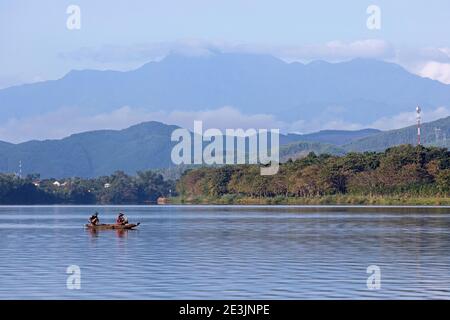 Vietnamese family in small traditional boat on the Perfume River near Hue, Thừa Thiên-Huế Province, central Vietnam Stock Photo