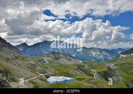 Majestic mountain landscape with lake from Les Arcs 2000 ski station in Red Peaks massif in summer. Savoie, France. Stock Photo