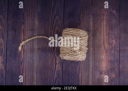 a dark craft thread on wooden background Stock Photo