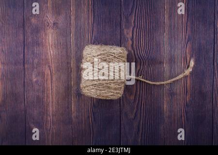 a dark craft thread on wooden background Stock Photo