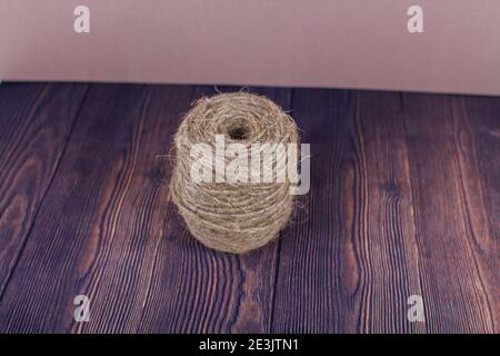 a dark craft thread on wooden background Stock Photo