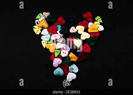 Heart shaped buttons on a black background. Stock Photo