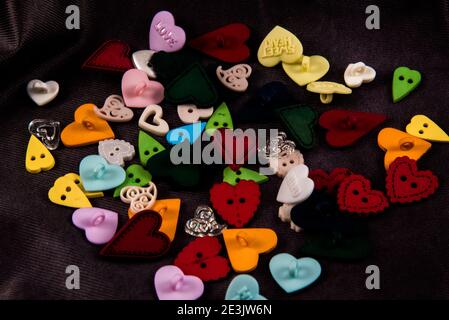 Heart shaped buttons on a black background. Stock Photo