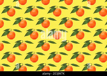 Yellow tangerines pattern on yellow background. Fruit seamless pattern themes for wallpaper, textile, background, poster, cover of book, post cards.