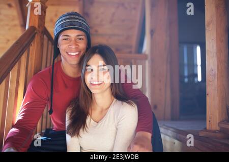 Couple sitting on indoor cabin steps in the morning Stock Photo