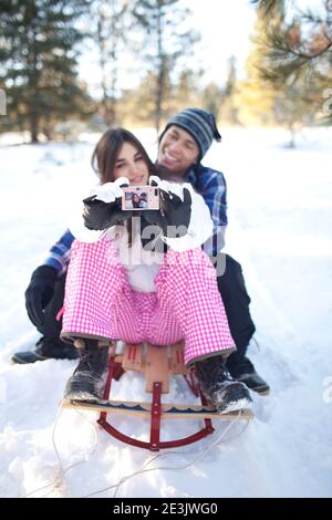Couple taking selfie in snowy forest Stock Photo