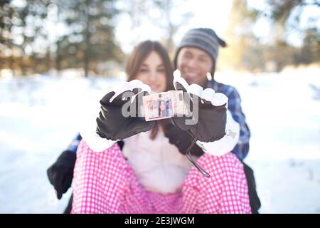 Couple taking selfie in snowy forest Stock Photo