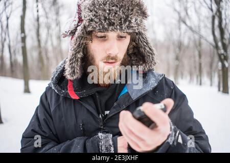 Young man enjoying canadian winter in forest, Mont Royal, Montreal, Quebec, Canada Stock Photo