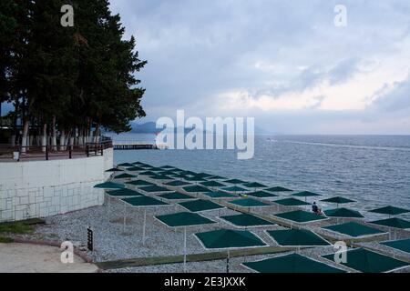 Beach with sunbeds, umbrellas on the mediterranean sea coast in Turkey Stock Photo