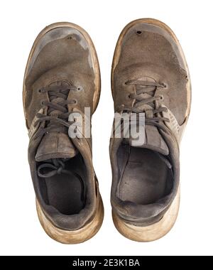 a pair of weared dirty sneakers isolated on white background,, flat lay perspective vew from above Stock Photo