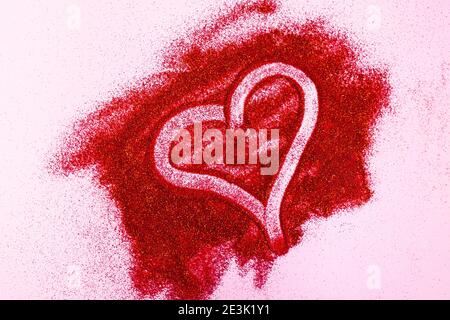 Hearts painted by finger on red glitter. Valentine's Day concept Stock Photo